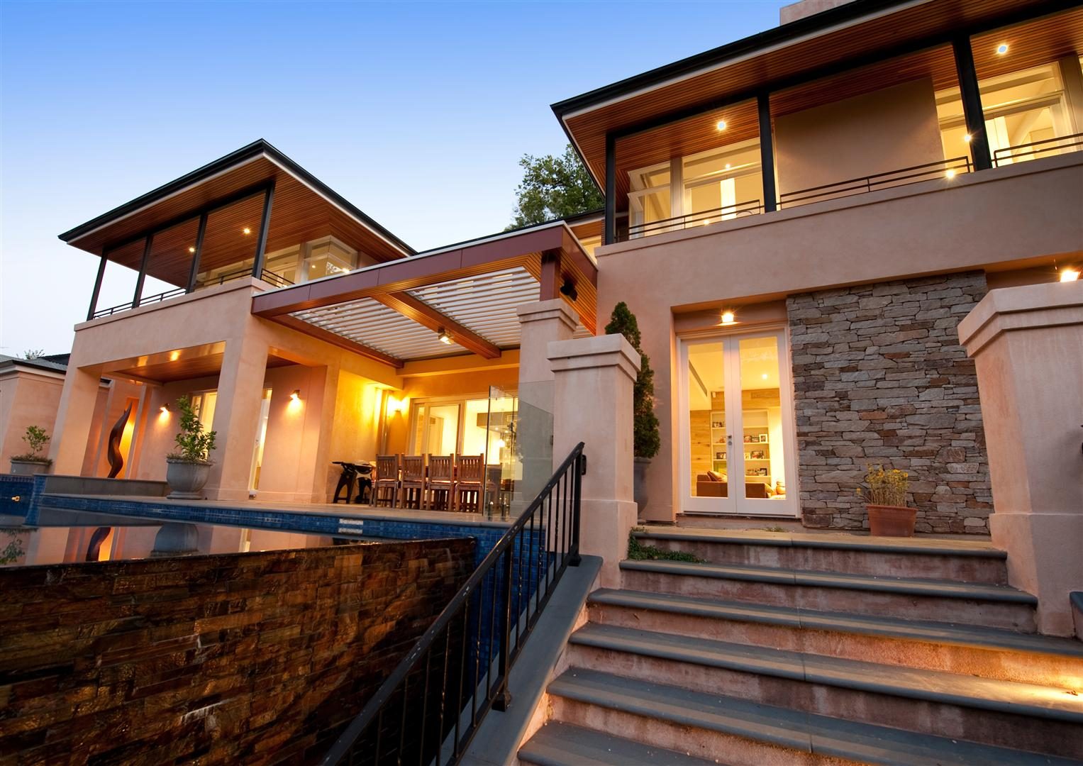 Aldgate Residence — a multi-level home of stone, timber and glass at dusk, Adelaide Hills