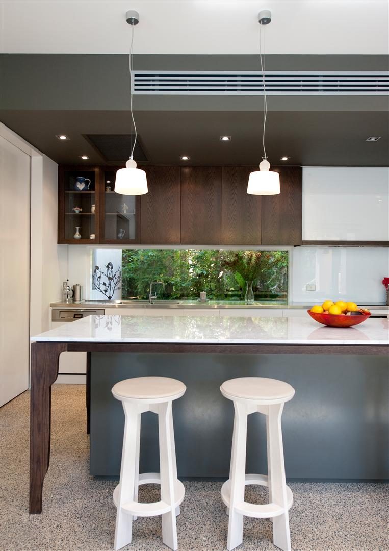Kitchen — island bench with stools, dark cabinetry and a window splashback